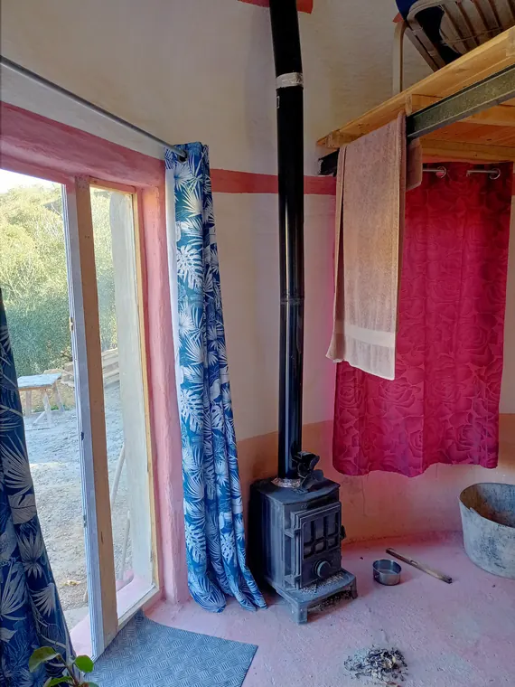 Interior of a round home with a door to the land